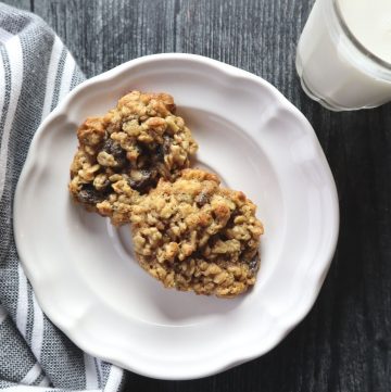 oatmeal raisin cookies on a plate, with glass of milk